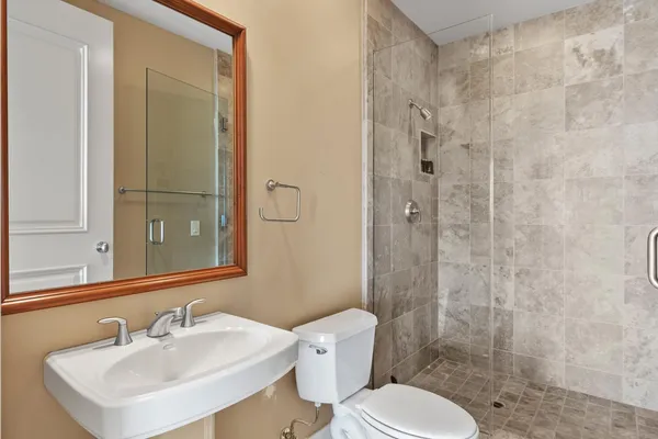 a bathroom with a sink toilet and shower