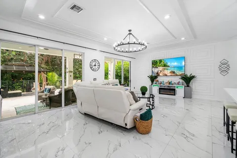 a living room with furniture and a chandelier