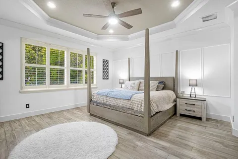 a spacious bedroom with a large bed and a large window