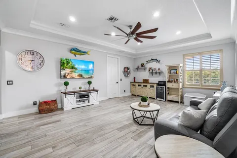 a living room with furniture a window and a flat screen tv
