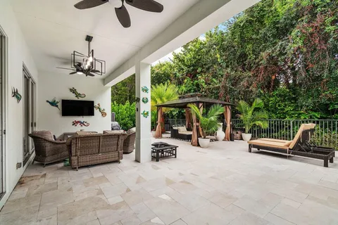 a view of a patio with couches chairs and a potted plant