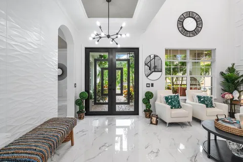 a spacious bedroom with a bed and a chandelier