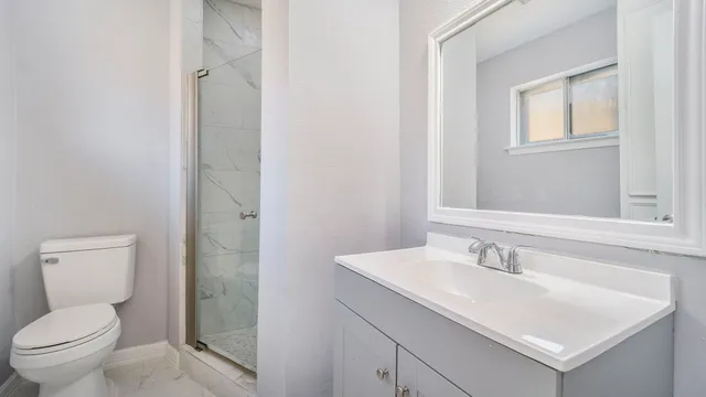an empty room with wooden floor chandelier fan and closet area