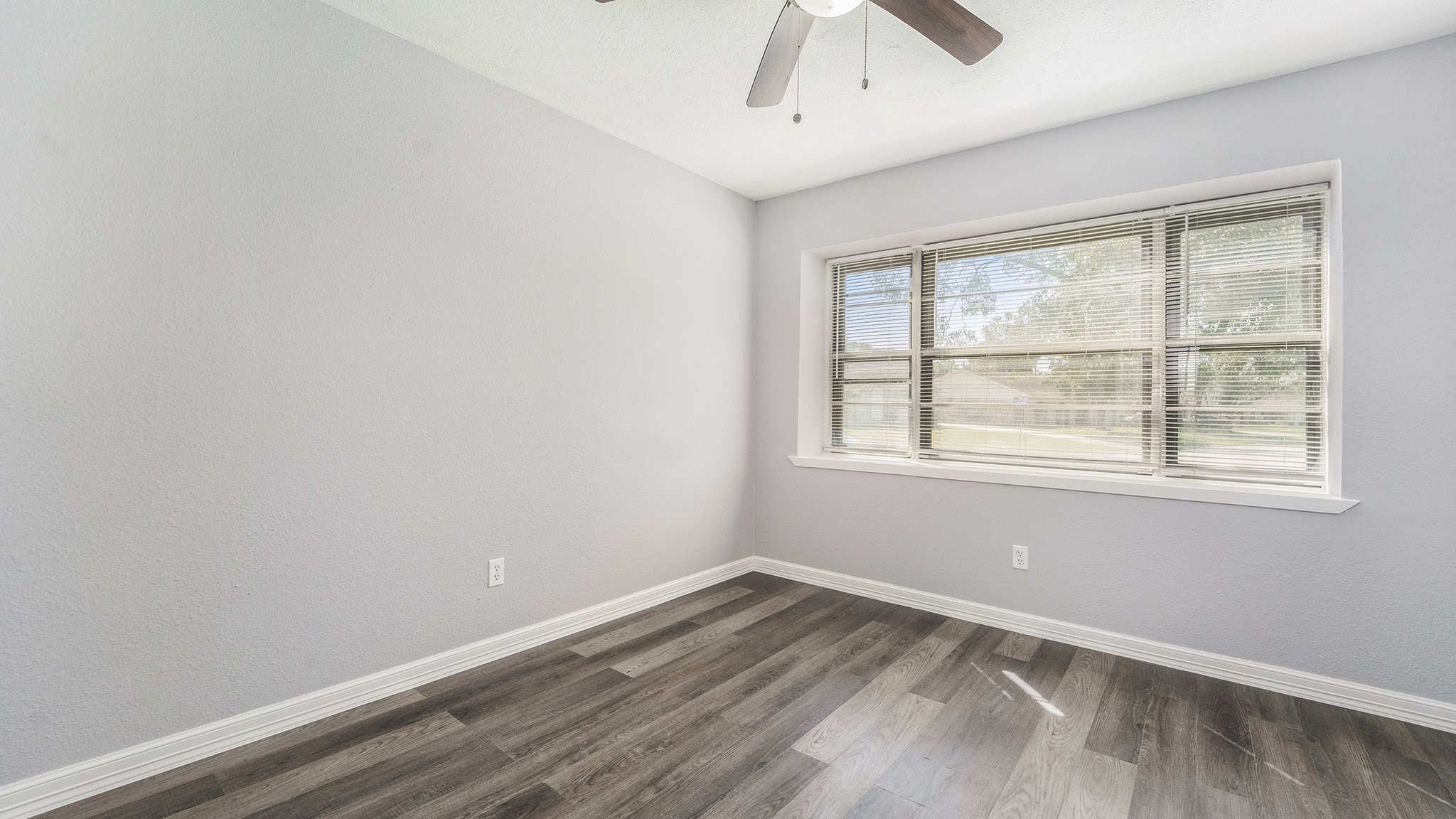 3008 Columbia Street Baytown, TX 77521 - Photo 16 of 23 an empty room with a window and wooden floor
