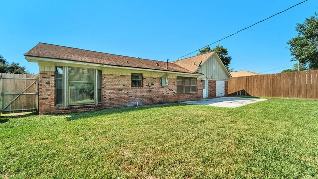 a view of a house with a yard and garage