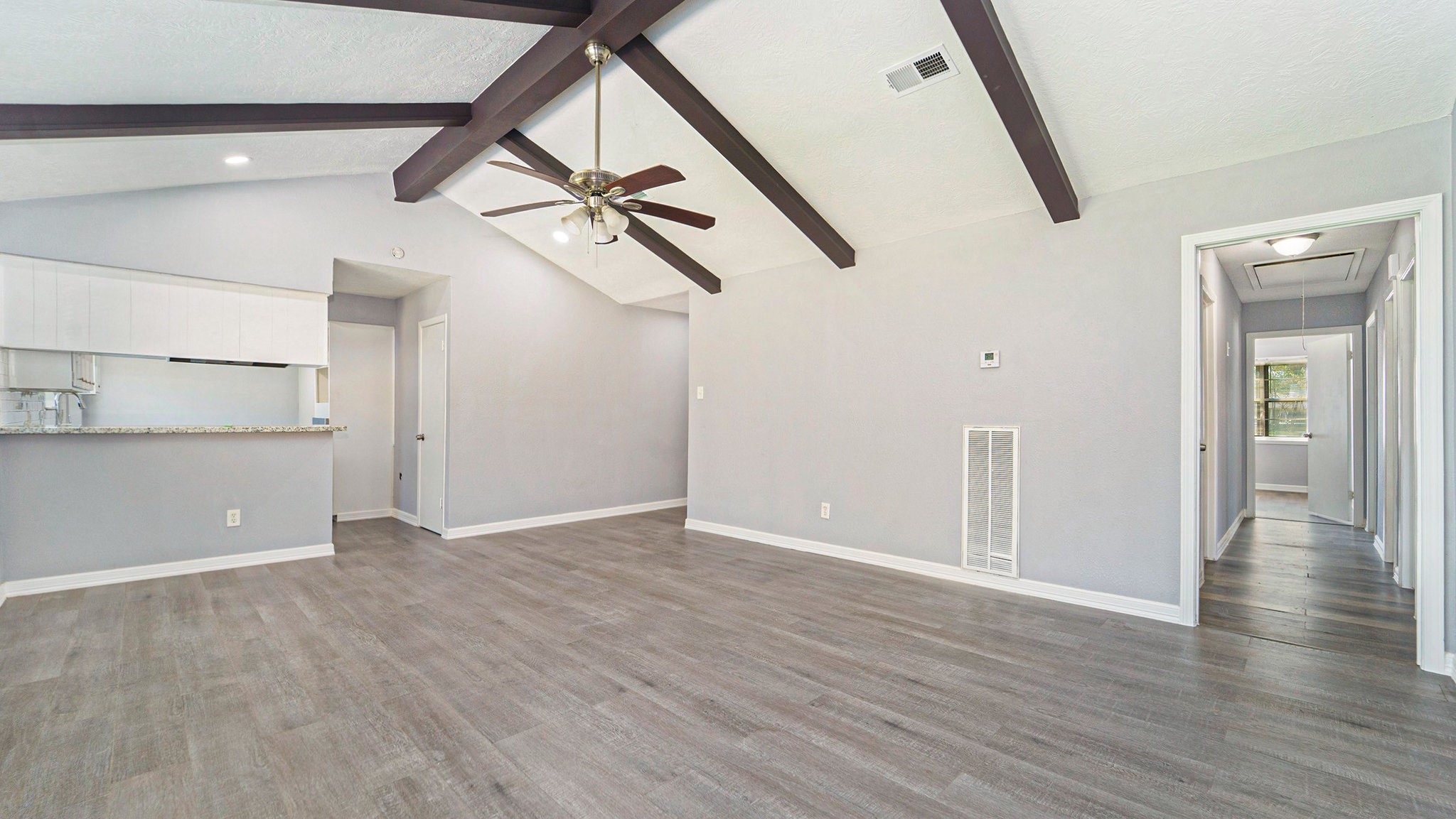 3008 Columbia Street Baytown, TX 77521 - Photo 3 of 23 wooden floor in an empty room with a window