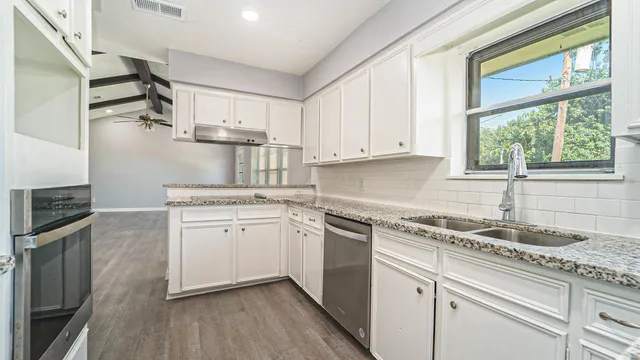 a kitchen with a stove a refrigerator and cabinets