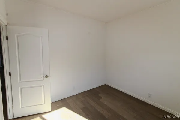 an empty room with wooden floor