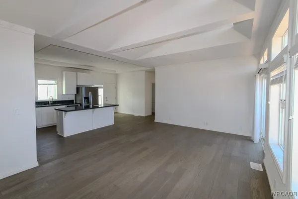 a view of kitchen with sink refrigerator and window