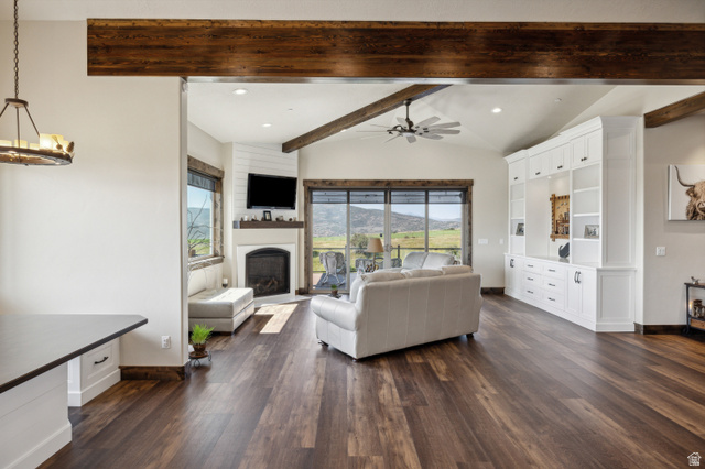 6117 North Rocky Ridge Road Peoa, UT 84061 - Photo 39 of 82 Spacious living area featuring wood-finish flooring, exposed ceiling beams, and a vaulted ceiling