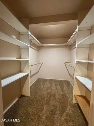 a view of an empty room with empty shelves