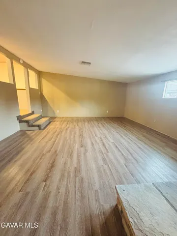 a view of an empty room and wooden floor