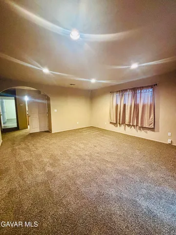 an empty room with a empty space and windows