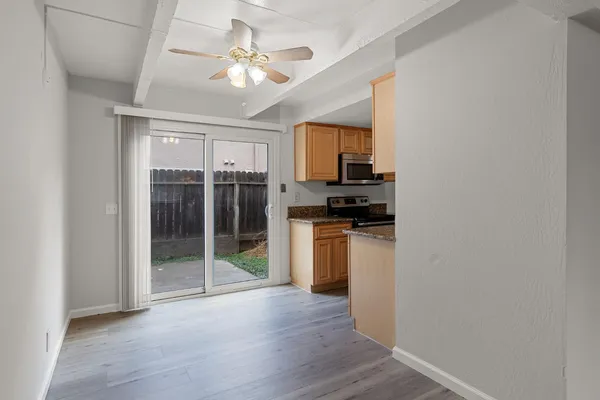 a view of kitchen with sink and refrigerator