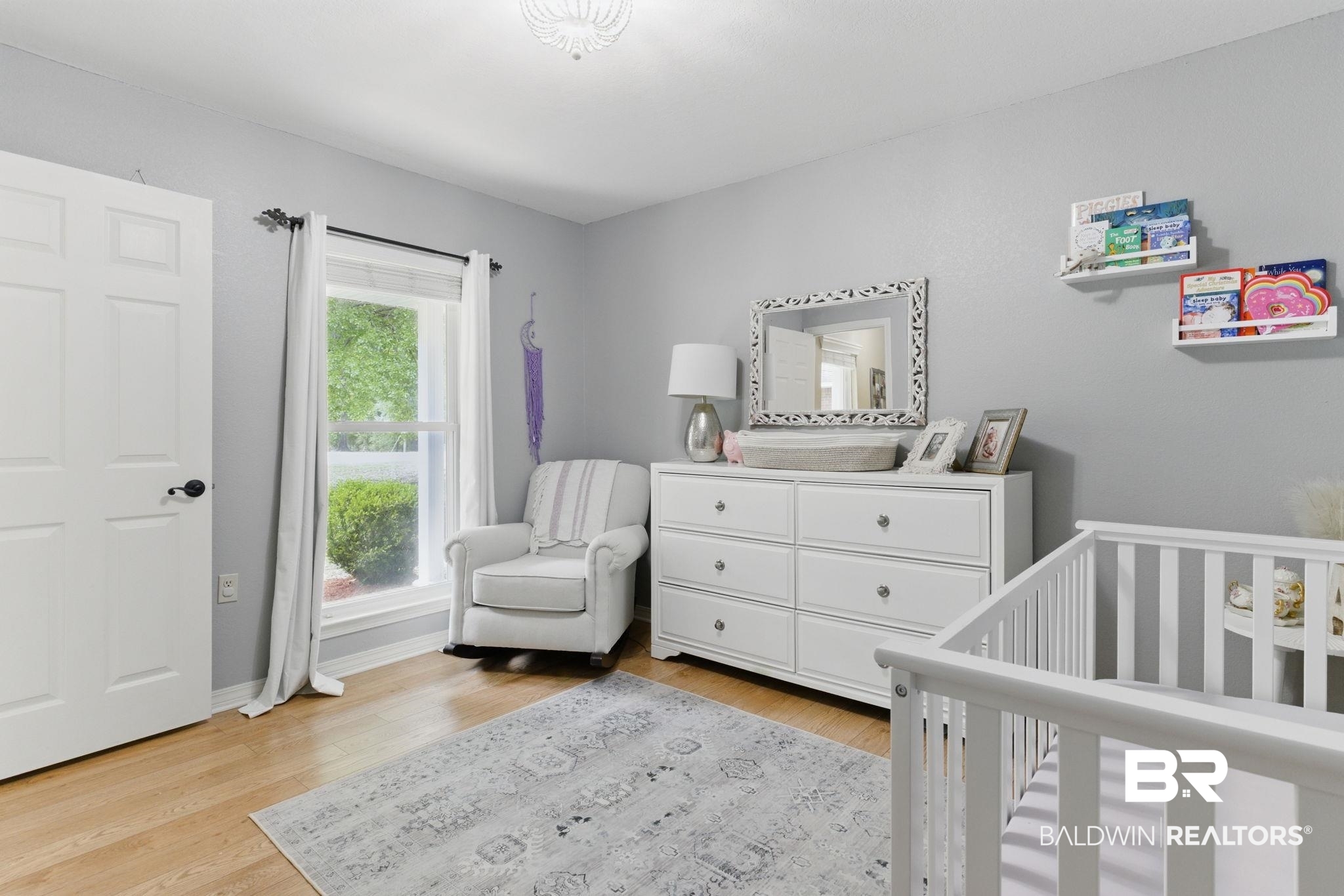 32345 River Lake Road Seminole, AL 36574 - Photo 33 of 56 Bedroom featuring a crib, light wood-style floors, and baseboards