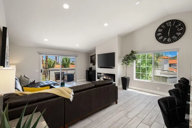 a living room with furniture a window and a flat screen tv