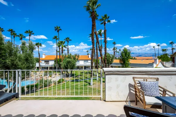a view of a chair and tables in the balcony