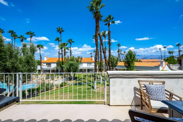 a view of a chair and tables in the balcony