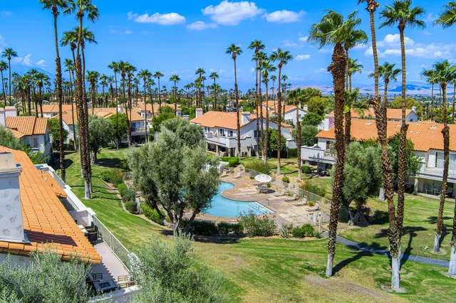 a view of a swimming pool and outdoor seating