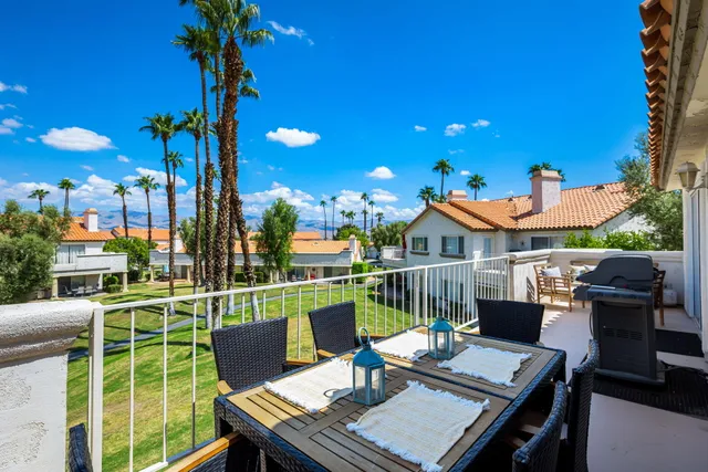 a view of a house with a backyard and a tree