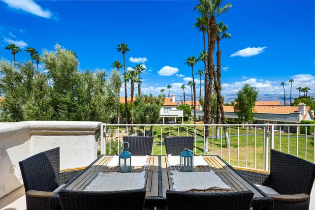 a spacious bedroom with a large bed and a chandelier
