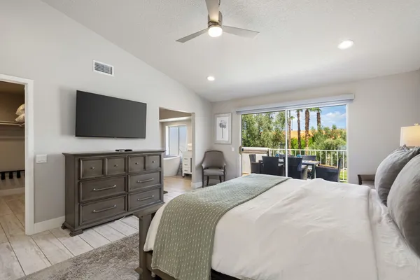 a spacious bathroom with a double vanity sink a mirror and a bathtub