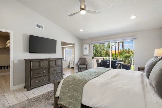 a spacious bathroom with a double vanity sink a mirror and a bathtub