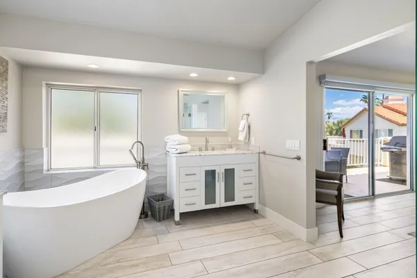 a bedroom with a bed and a mirror