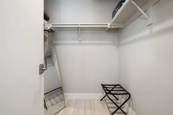 a bedroom with a large bed and a chandelier