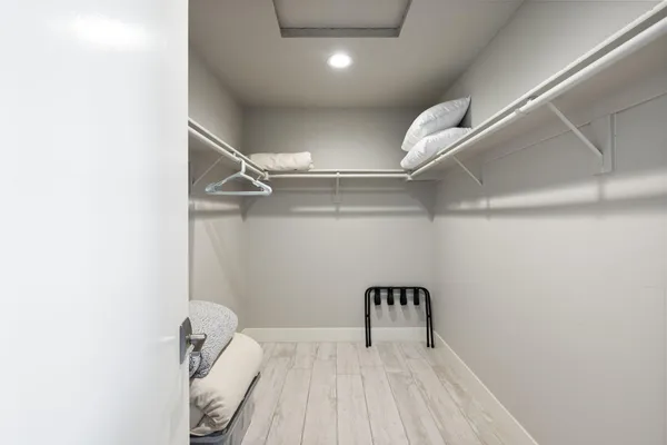 a bathroom with a granite countertop toilet sink and mirror