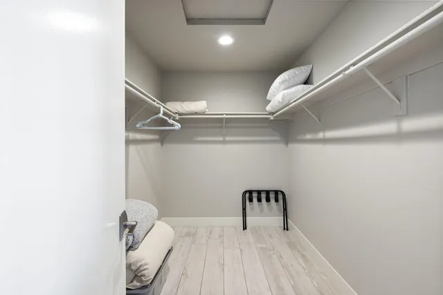 a bathroom with a granite countertop toilet sink and mirror