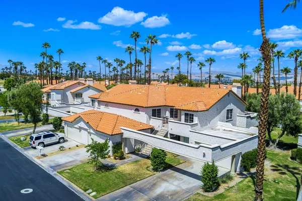 a view of a patio with a dining table and chairs with a fire pit