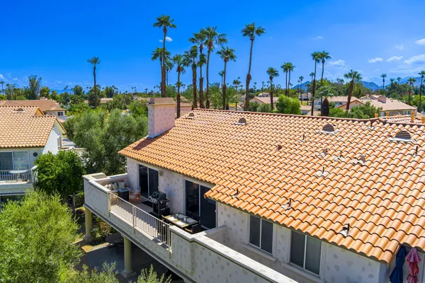a front view of a multi story building with yard