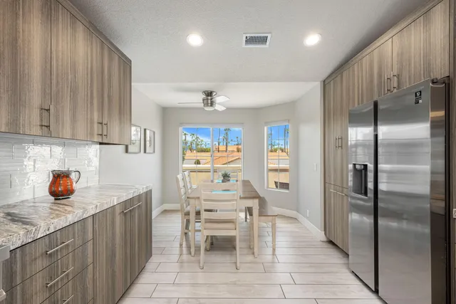 a kitchen with stainless steel appliances granite countertop a refrigerator and a sink