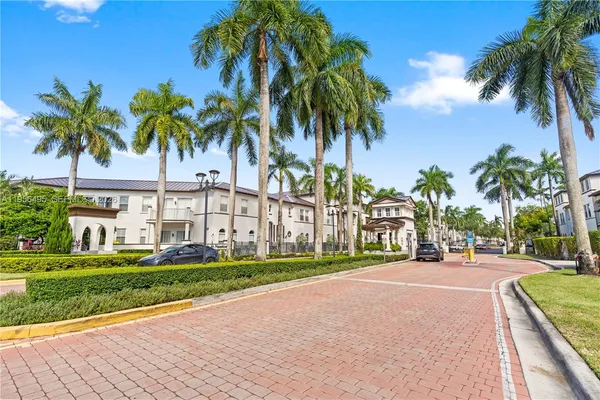 a row of palm trees in front of a house