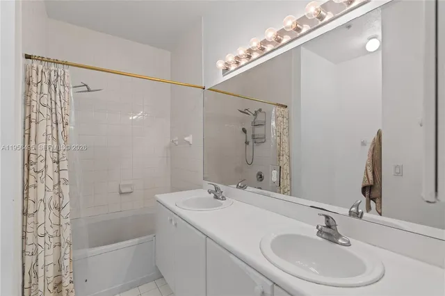 a bathroom with a sink a mirror and a shower
