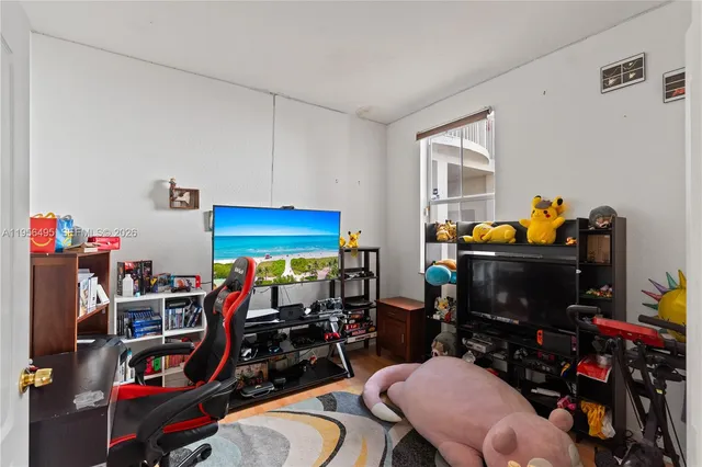 a room with gym equipment and a flat screen tv