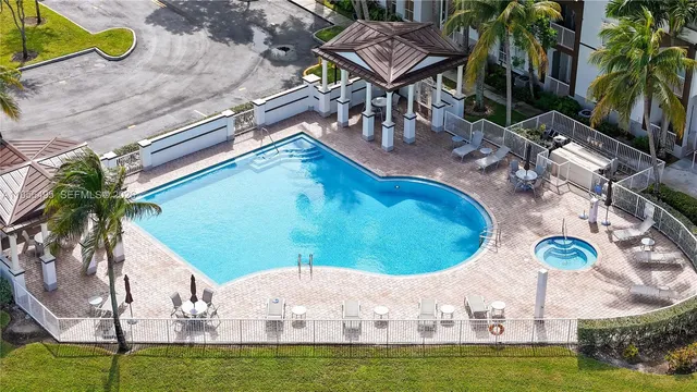 an aerial view of a house with a garden and trees