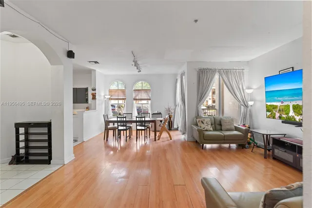 a living room with furniture and a wooden floor