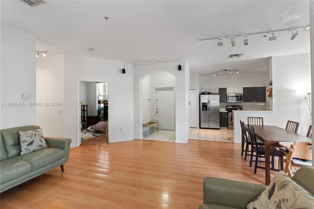 a living room with furniture and kitchen view