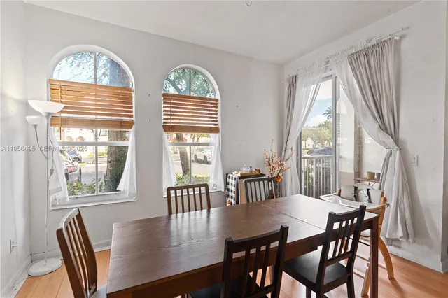 a view of a dining room with furniture window and wooden floor