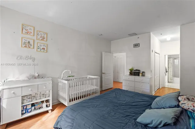 a living room with furniture and a baby crib