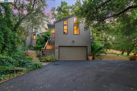 an aerial view of a house with table and chairs and potted plants
