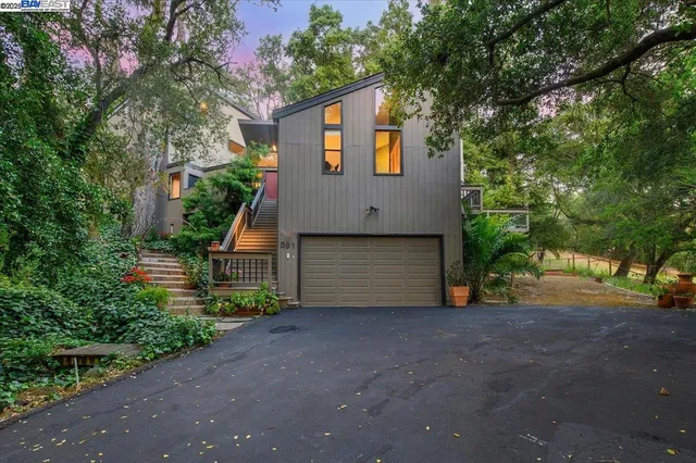 an aerial view of a house with table and chairs and potted plants
