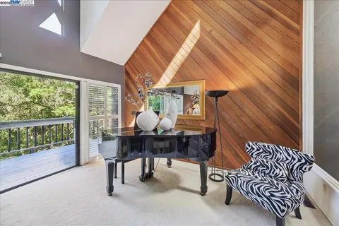 a view of a dining room with furniture large windows and wooden floor