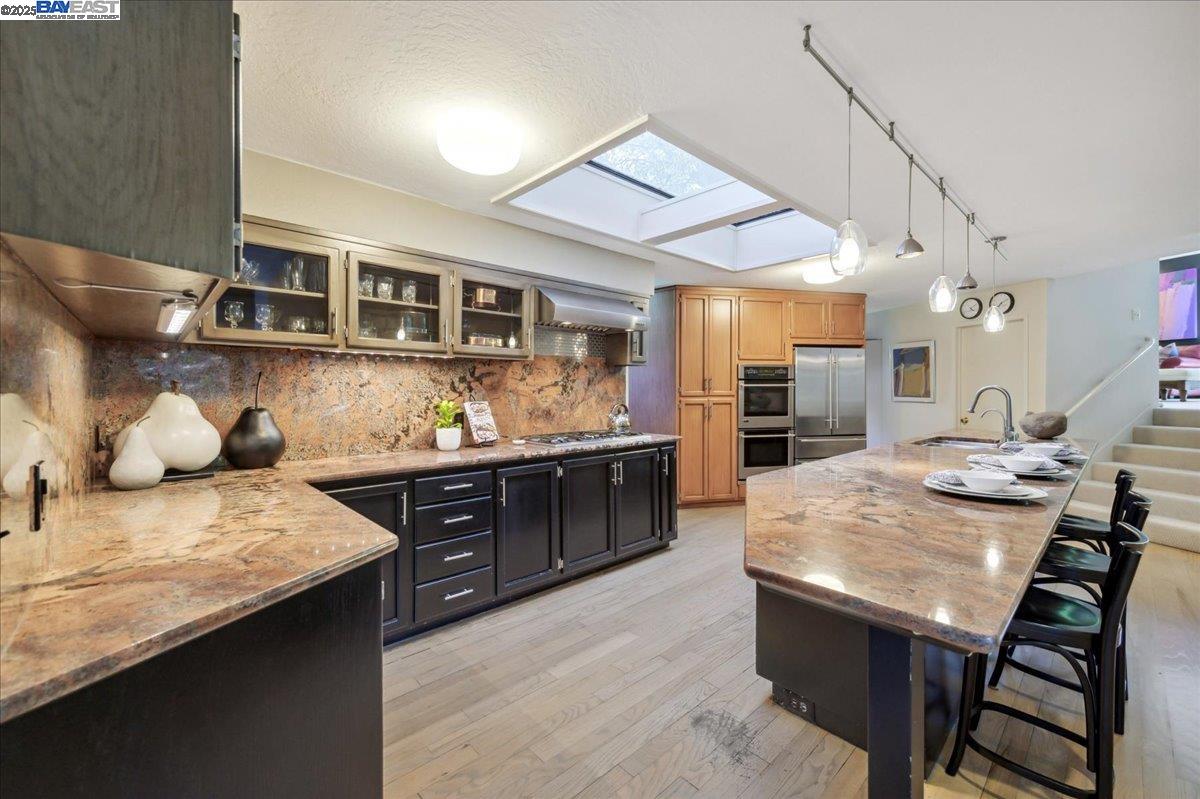 391 Oak Lane Pleasanton, CA 94566 - Photo 23 of 60 a kitchen with stainless steel appliances granite countertop a stove a sink and a refrigerator
