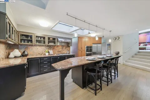 a spacious bathroom with a double vanity sink a large mirror and a large window