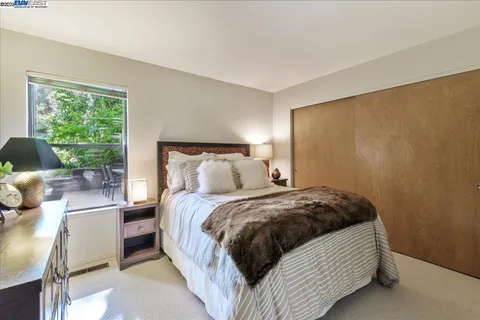 a bathroom with a toilet a sink a mirror and a shower