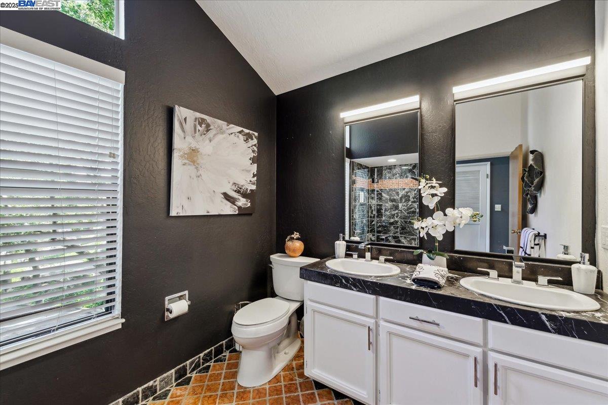 391 Oak Lane Pleasanton, CA 94566 - Photo 38 of 60 a bathroom with a toilet a sink a mirror and a shower