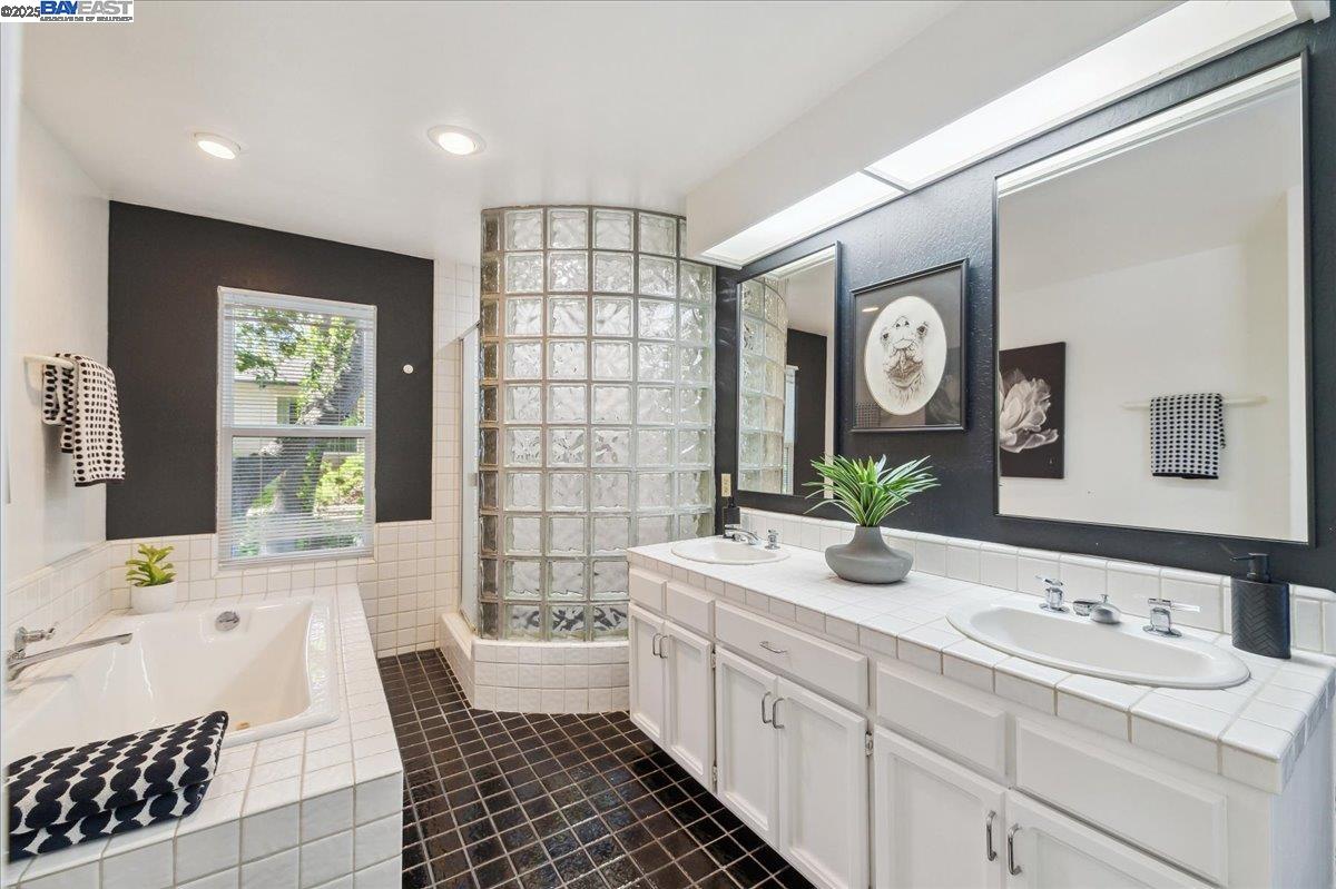 391 Oak Lane Pleasanton, CA 94566 - Photo 49 of 60 a bathroom with a double vanity sink mirror and bathtub